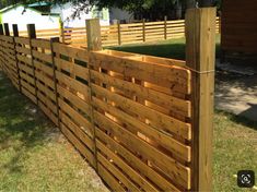 a wooden fence in the middle of a yard