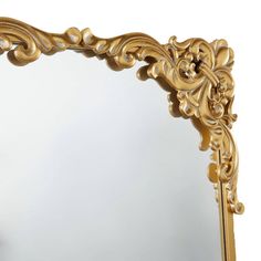 an ornate gold framed mirror on a white background