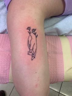 a small penguin tattoo on the right arm and leg, with roses in it's beak