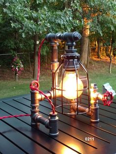 a light that is sitting on top of a table in front of some grass and trees