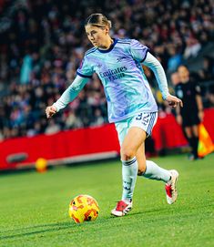 a female soccer player in action on the field