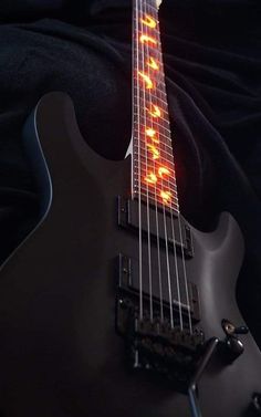 an electric guitar with the strings glowing orange