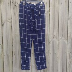 Nwt Express Ankle High Rise Tie Waist Navy Blue And White Plaid Trouser Pants With Side Pockets And Zip Button Hook Fly. Belt Loops Around Waist And Tapered At The Legs. 100% Polyester Fabric Composition,. In Excellent Condition. Size 4r 18" Waist 11" Rise 10" Inseam 20" Total Length Bundle This + 1 More To Get 20% Off And 5.95 Shipping New To Poshmark? Get $10 Signing Up When You Use The Code: Nachobabycakes Measurements Are By Hand To The Best Of My Human Ability. If You Require More Specific Navy Pants For Business Casual In Spring, Navy Ankle-length Pants For Spring, Blue Tapered Leg Bottoms For Day Out, Business Casual Trousers, Plaid Trousers, Relaxed Trousers, Stretch Dress Pants, Belted Pants, Bootcut Pants