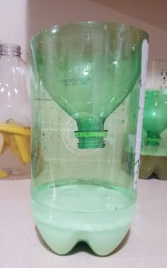 an empty green glass sitting on top of a table