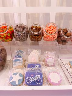 an assortment of cookies and candies displayed in plastic containers