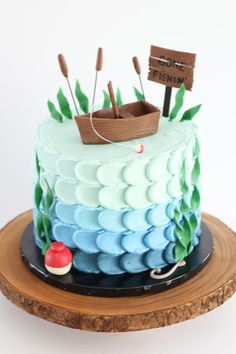 there is a cake decorated with an image of a boat on the water and seaweed