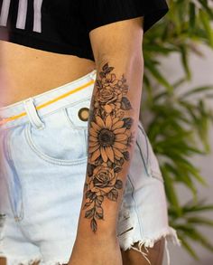 a woman with a sunflower tattoo on her arm