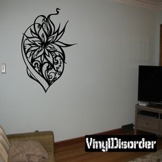 a living room with a couch, television and wall decal in the shape of a heart