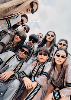 a group of young people wearing sunglasses posing for the camera