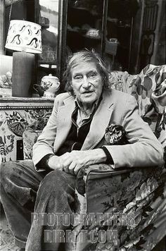 black and white photograph of an old man sitting on a couch