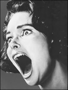 an old photo of a woman screaming with her mouth open