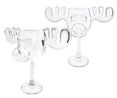 two wine glasses sitting next to each other on top of a white surface with an animal head