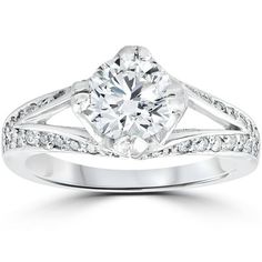 a diamond engagement ring with diamonds on the band and shoulders, set in 18k white gold