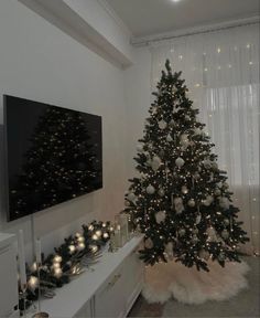 a living room with a christmas tree in the corner