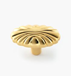 an image of a gold knob on a white background in the shape of a flower