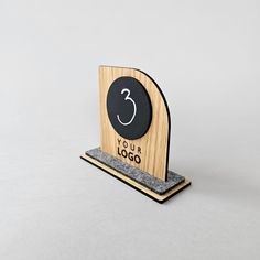 a wooden stand with a black and white clock on it