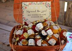 a basket filled with lots of jams sitting on top of a wooden table next to a sign that says spread the last help yourself to some homemade jam