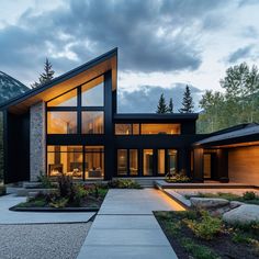 a modern house in the mountains at dusk