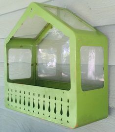 a green window on the side of a building