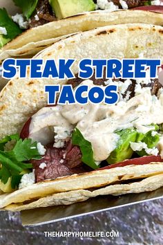 two steak street tacos with lettuce and tomatoes