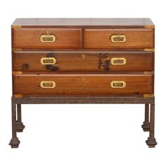 an old wooden dresser with brass handles on it's sides and two drawers in the middle