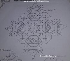 an intricate design is drawn on paper with some lines and dots in the middle, as well as other patterns