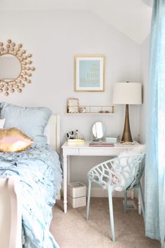 a bed room with a neatly made bed and a mirror on the wall above it