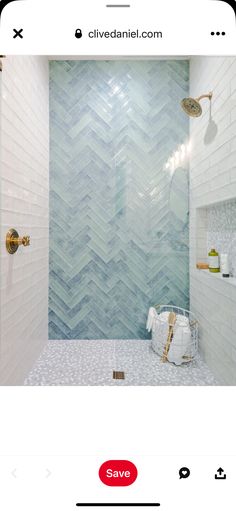 the bathroom is decorated in white and blue tones with herringbone tile on the shower wall