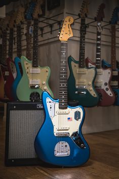 an electric guitar sits in front of other guitars