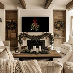 a living room decorated for christmas with wreaths on the mantel and fireplace mantle