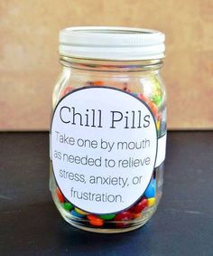 a jar filled with colorful candy sitting on top of a table