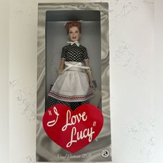 a doll in a box with the words i love lucy on it's back