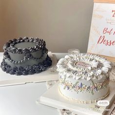 two cakes sitting next to each other on top of a table