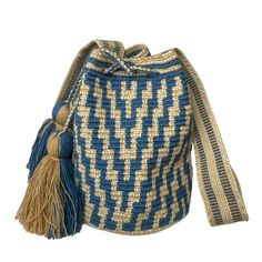 a blue and white woven bag with tassels