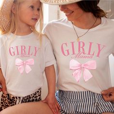 Unleash your girly side with the Girly Mama & Mini Tees. Featuring adorable bows and perfect for matching with your mini me, these tees are made for the ultimate girly duo. Perfect for moms and daughters who love to have fun and look cute! Design is Printed Direct to Garment. Fun Pink Tops For Family Occasions, Cute T-shirt For Spring Gender Reveal, Cute Spring T-shirt For Gender Reveal, Playful Pink Tops For Mother's Day, Cute Pink Tops For Family Occasions, Playful Pink T-shirt For Gender Reveal, Pink Matching Top For Gender Reveal, Pink Family Matching Tops For Gender Reveal, Family Matching Pink Tops For Gender Reveal