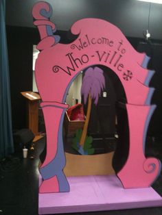 a pink sign that says welcome to whoville