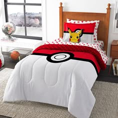 a bedroom with pokemon bedding and pillows