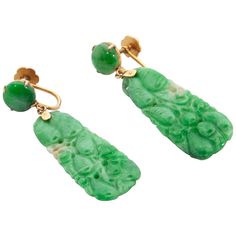 These gorgeous carved jade earrings are certified as untreated. The jade earrings are made in 14 karat gold with carved green and white mottled jade panels. The natural jadeite jade panel earrings are hung on a small gold hook. Each earring is crafted with a round cabochon green jade stone. On both sides of the panels, the jade is carved into a beautiful fruit design. The earrings are characterized by their screw back design. It is believed carved jade represents purity, beauty, longevity and ev White Diamond Earrings, Jewellery Vintage, Platinum Earrings, Types Of Earrings, Carved Jade, Unusual Earrings, Gold Dangle Earrings, Diamond Collection, Diamond Dangle Earrings