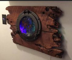 a piece of wood with a blue light in the center and some sort of thing on it