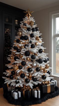 a white christmas tree with black and gold ornaments