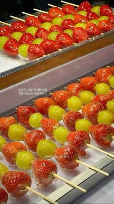 there are many strawberries and lemons on the skewers in this case