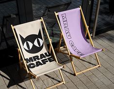 two lawn chairs sitting next to each other on a sidewalk