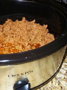 a crock pot filled with food sitting on top of a counter