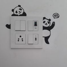 a panda bear wall sticker on the side of a light switch