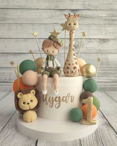 a cake decorated with animals, giraffes and stars