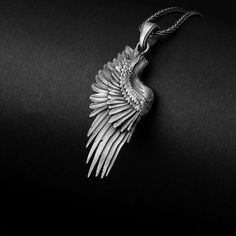 Embrace the beauty and elegance of this sterling silver wing necklace, a symbol of freedom, protection, and divine guidance. The intricate feather detail and delicate design create a captivating accessory that speaks to the soaring spirit within you. Let this stunning pendant serve as a reminder of your guardian angel, watching over and guiding you through life's journey. This spiritual piece of jewelry is the perfect gift for someone who needs inspiration or encouragement. With its grace, the s Silver Winged Engraved Jewelry, Silver Feathered Sterling Silver Necklaces, Spiritual Winged Sterling Silver Jewelry, Silver Sterling Silver Necklaces With Feathers, Silver Feather Pendant Jewelry, Engraved Winged Sterling Silver Jewelry, Elegant Sterling Silver Feather Jewelry, Sterling Silver Wing-shaped Necklace, Sterling Silver Angel Wings Pendant Jewelry