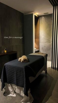 a massage room with towels on the bed