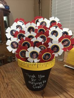 a vase filled with red and white flowers