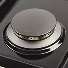 a close up of a stove top with a knob