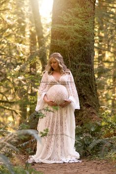 Pregnant woman in white lace maternity gown standing in forest Maternity Hairstyles Photography, Woods Maternity Pictures, Photos In Woods, Fairy Maternity Shoot, Woods Maternity Shoot, Woodsy Maternity Pictures, Creek Maternity Pictures, Wedding Under Trees, River Maternity Shoot